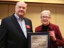West Gulf Division Director Dr David Woolweaver, K5RAV, receives his 50-year ARRL membership plaque from ARRL President Kay Craigie, N3KN. [Rick Lindquist, WW1ME, photo]